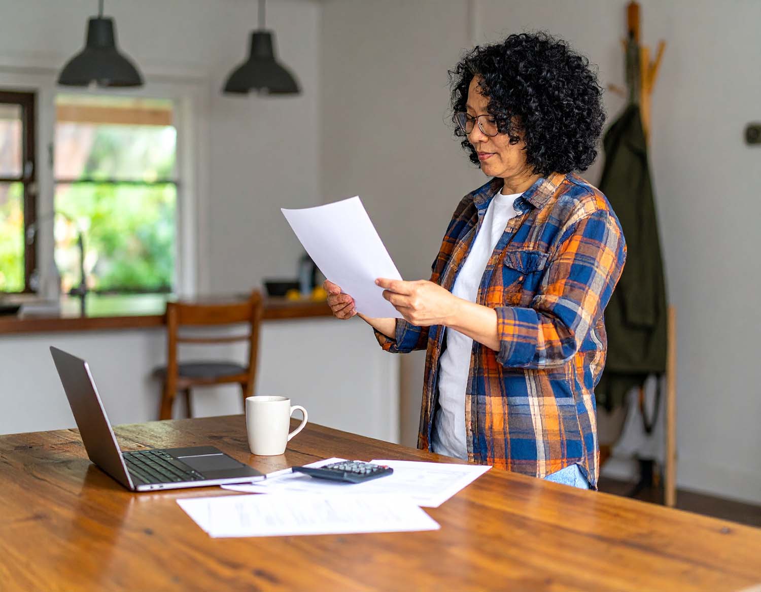 A Washington State landlord reviewing rental property finances at a kitchen table